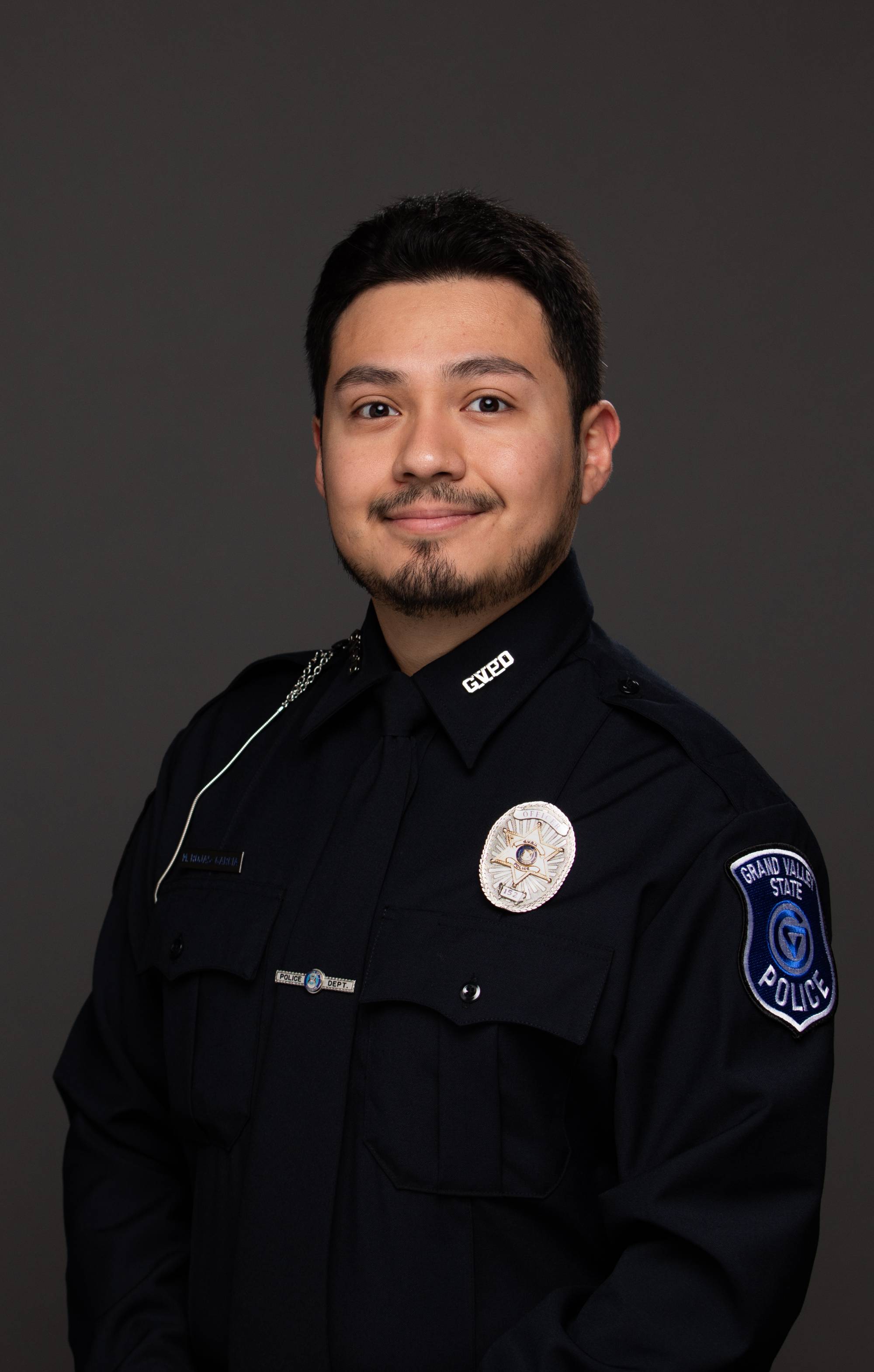 Headshot / portrait of Hispanic male police officer wearing a dress uniform